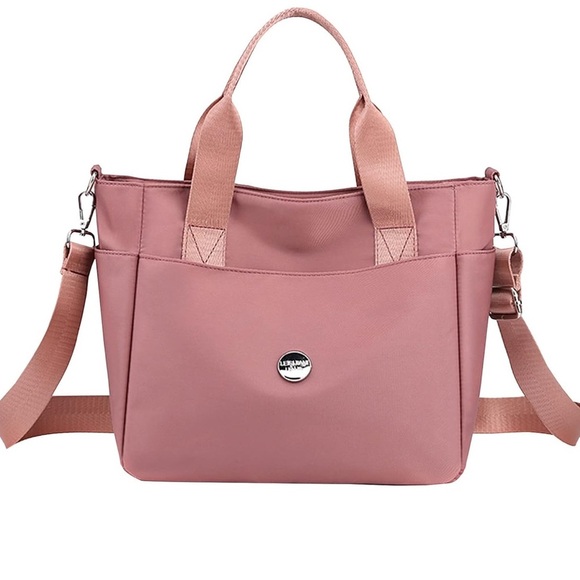 Nylon pink crossbody with shoulder handles. High density waterproof material. - Picture 1 of 14
